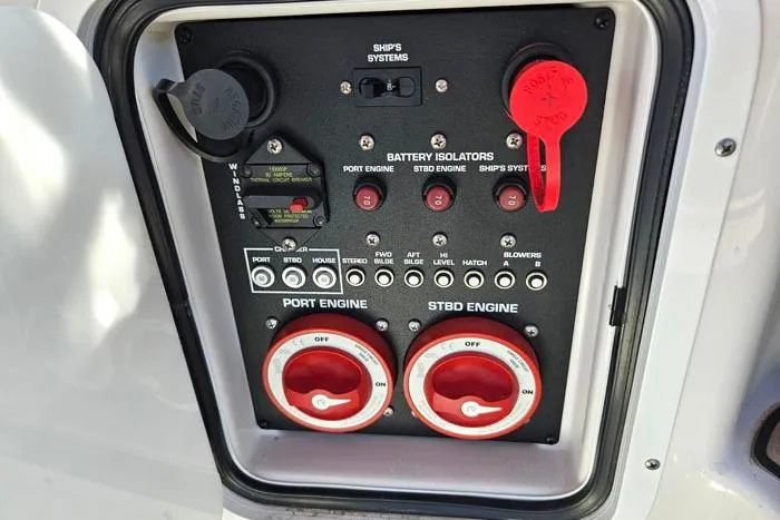 Slide: The Image of Control panel of a 2014 Four Winns V375 boat with battery isolators and engine switches. - 27