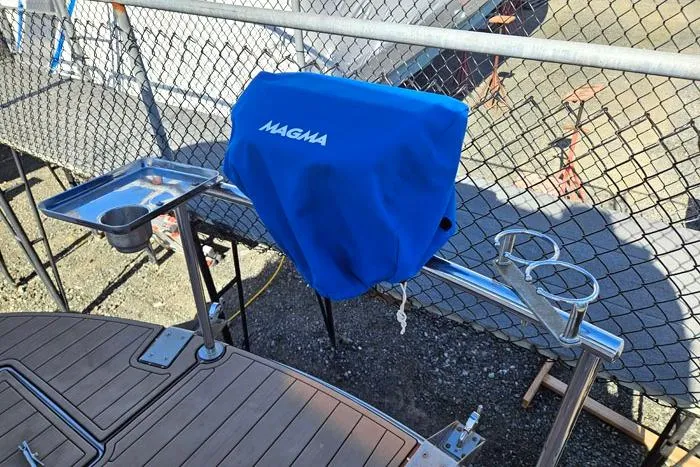 Slide: The Image of 2014 Four Winns V375 boat with Magma grill and cup holders on deck. - 30