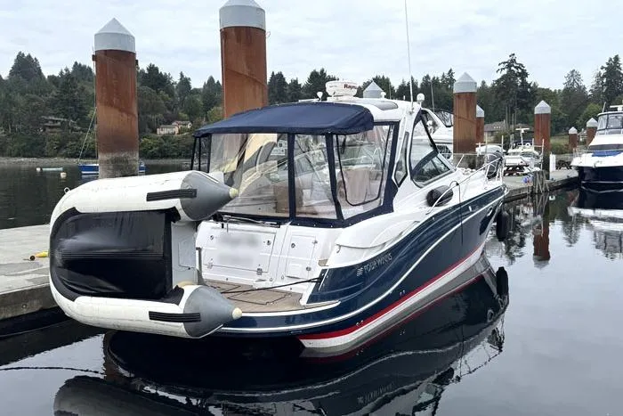 Slide: The Image of 2014 Four Winns V375 boat docked at marina with inflatable dinghy attached. - 35