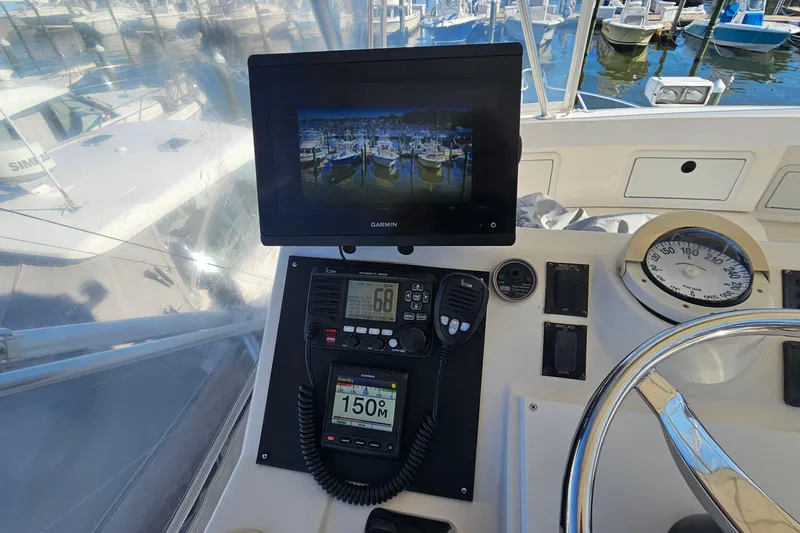 Slide: The Image of 2004 Luhrs 34 Convertible helm with Garmin display and navigation instruments. - 12