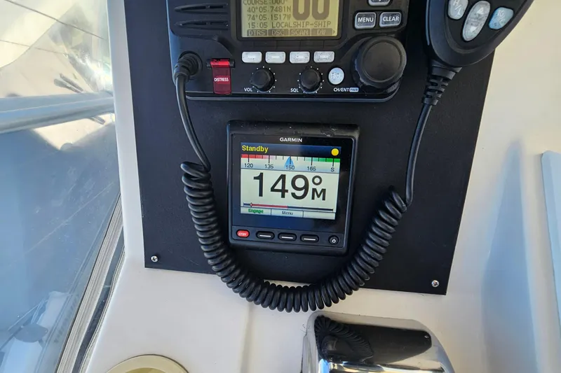 Slide: The Image of Control panel of a 2004 Luhrs 34 Convertible boat with Garmin navigation display. - 14
