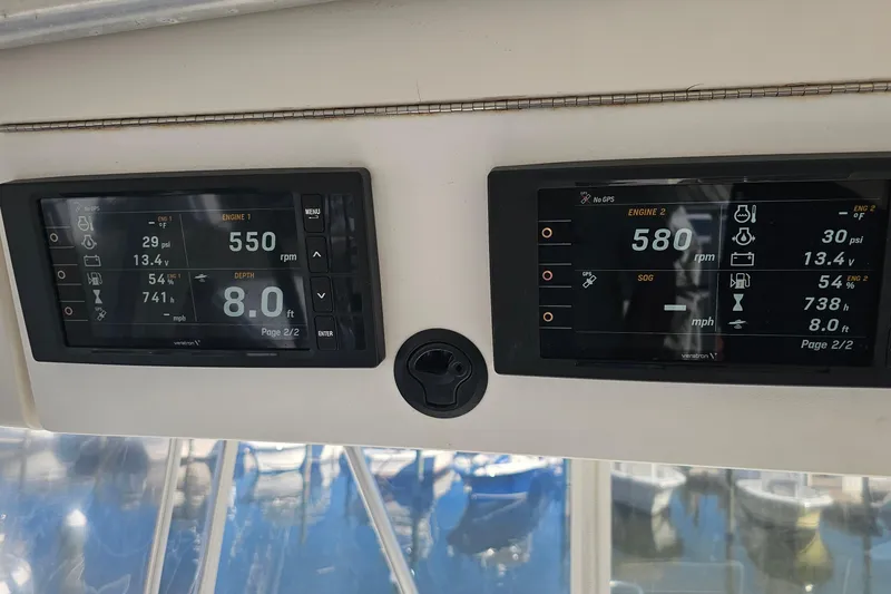 Slide: The Image of Luhrs 34 Convertible 2004 boat dashboard displaying engine and depth information. - 17