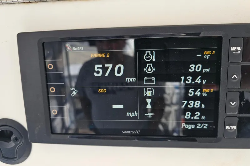 Slide: The Image of Luhrs 34 Convertible 2004 engine display showing RPM, PSI, voltage, and other metrics. - 19