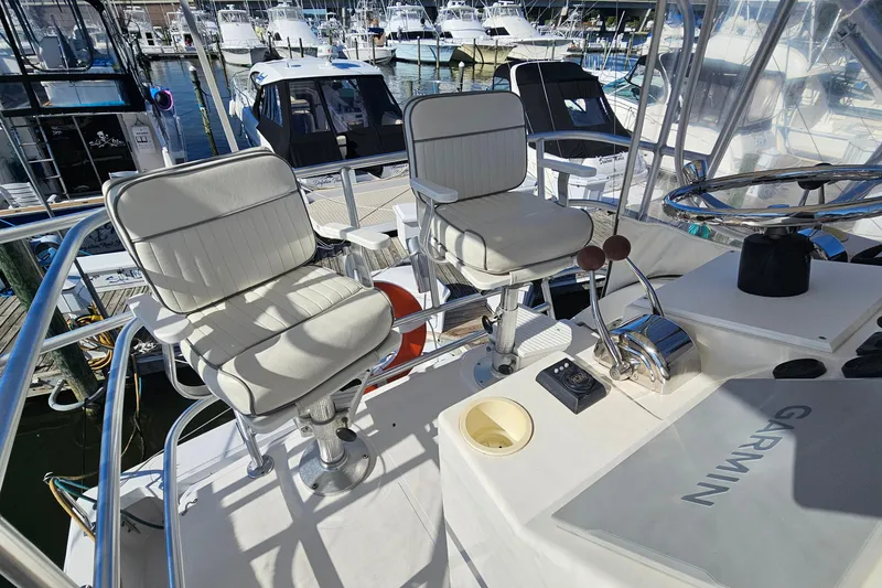 Slide: The Image of 2004 Luhrs 34 Convertible boat helm with dual seats and Garmin navigation. - 23