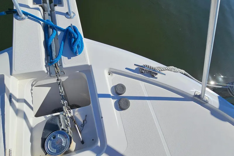 Slide: The Image of Bow of 2004 Luhrs 34 Convertible with anchor chain and blue rope. - 27