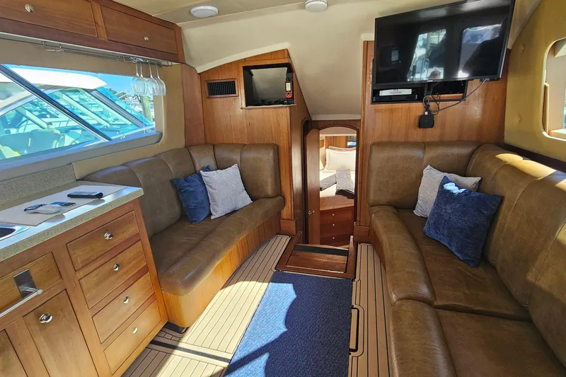Slide: The Image of Interior of 2004 Luhrs 34 Convertible yacht with cozy seating and modern amenities. - 29