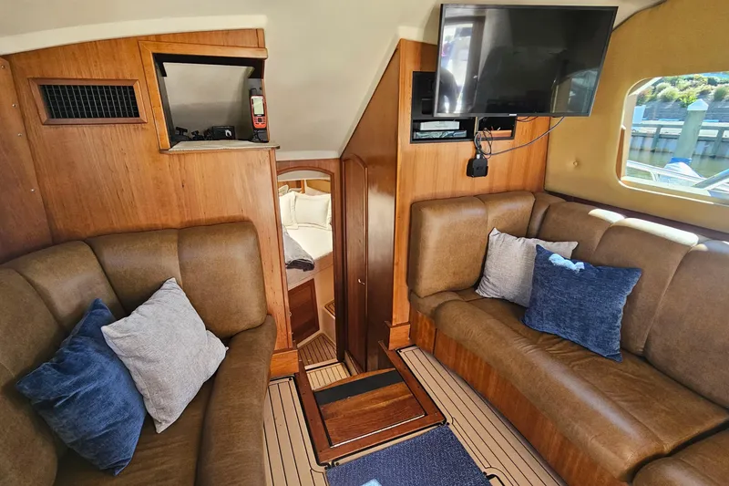 Slide: The Image of Interior of 2004 Luhrs 34 Convertible yacht with cozy seating and modern amenities. - 32