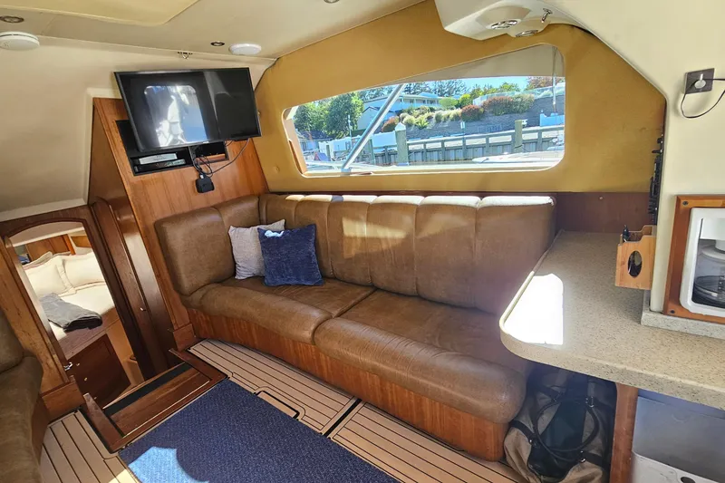Slide: The Image of Interior of 2004 Luhrs 34 Convertible yacht with leather seating and TV. - 33