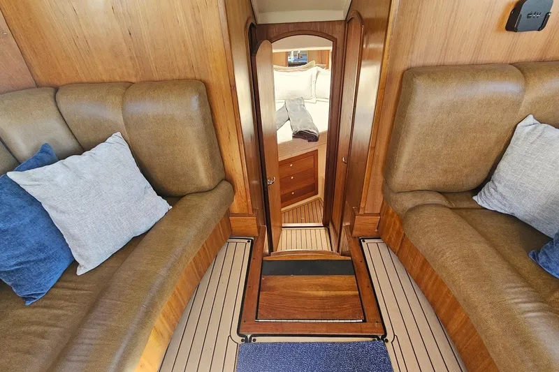 Slide: The Image of 2004 Luhrs 34 Convertible interior with cozy seating and elegant wood finish. - 34