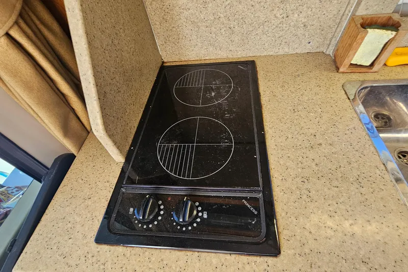 Slide: The Image of 2004 Luhrs 34 Convertible boat kitchen with electric stovetop and sink. - 37