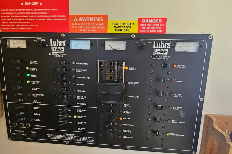 Slide: The Image of Luhrs 34 Convertible 2004 control panel with warning labels and switches. - 38