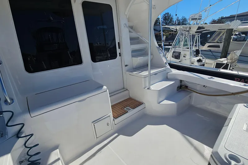 Slide: The Image of 2004 Luhrs 34 Convertible yacht deck with stairs and seating area. - 4