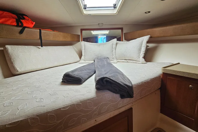 Slide: The Image of Cozy cabin interior of 2004 Luhrs 34 Convertible with bed and pillows. - 40