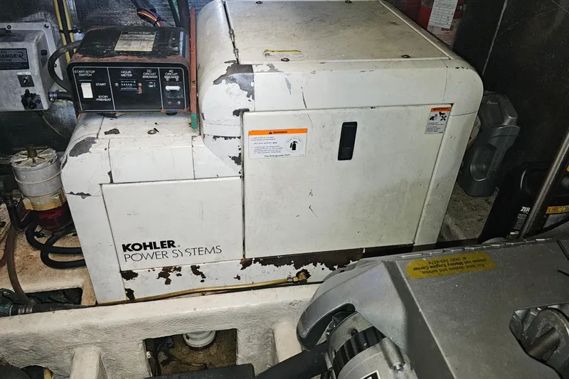 Slide: The Image of Kohler power system in 2004 Luhrs 34 Convertible engine room, showing control panel and generator. - 47