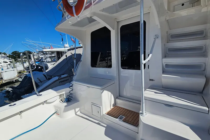 Slide: The Image of 2004 Luhrs 34 Convertible yacht deck with stairs and marina view. - 6