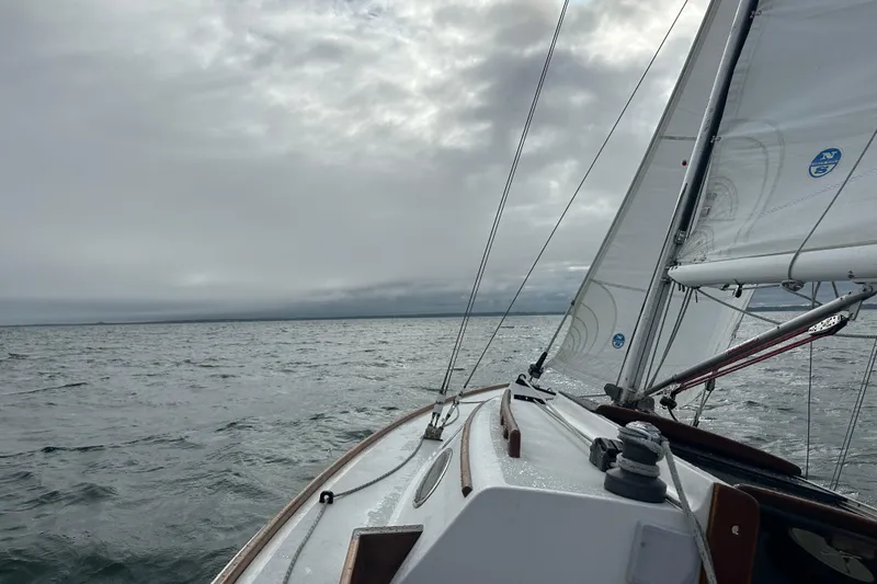 Slide: The Image of Sailing on a 1995 Alerion Express 28 under cloudy skies on open water. - 6