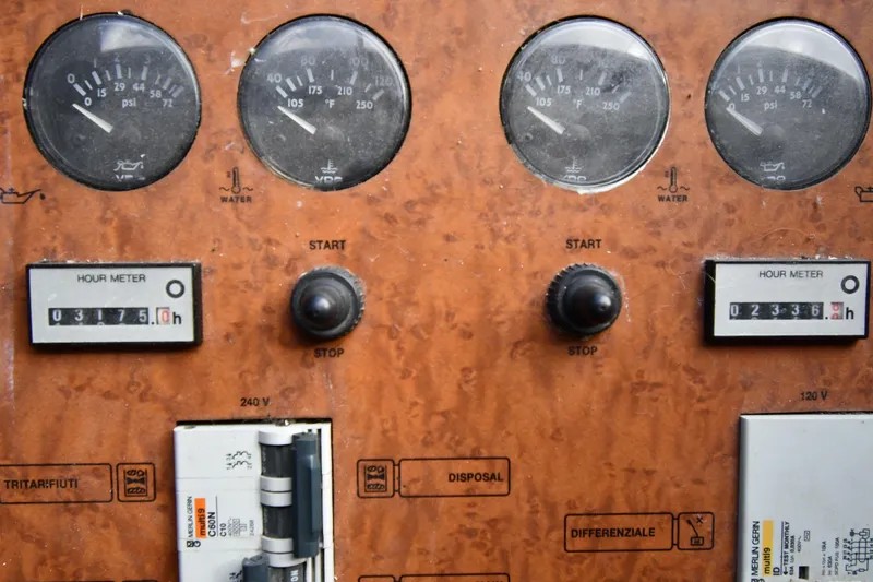 Slide: The Image of Control panel of a 2001 Ferretti Yachts 72, featuring gauges and hour meters. - 104