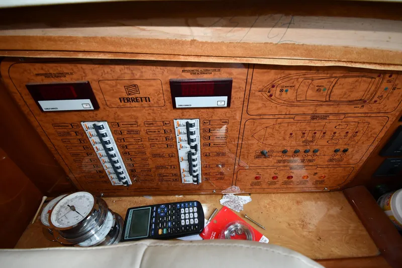 Slide: The Image of Control panel of a 2001 Ferretti Yachts 72, featuring switches and navigation tools. - 105