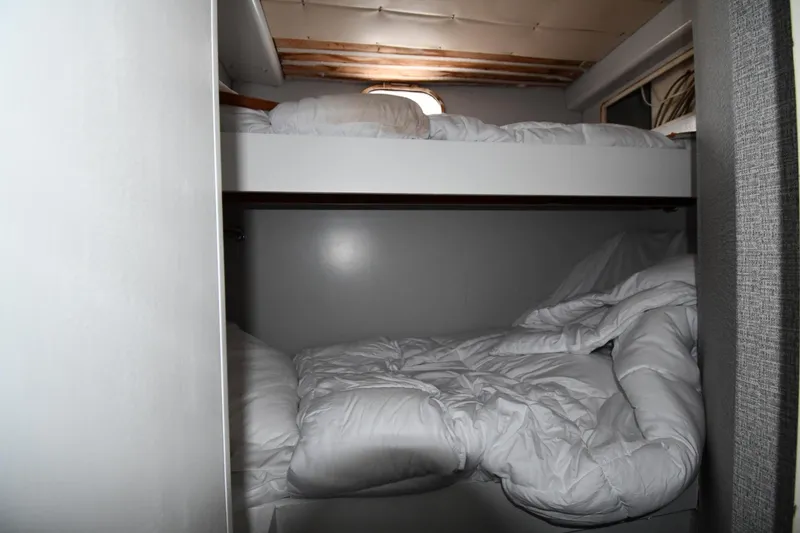 Slide: The Image of Bunk beds in 2001 Ferretti Yachts 72 cabin, featuring cozy white bedding. - 117