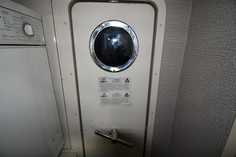 Slide: The Image of Interior of 2001 Ferretti Yachts 72, featuring a porthole and control panel. - 119