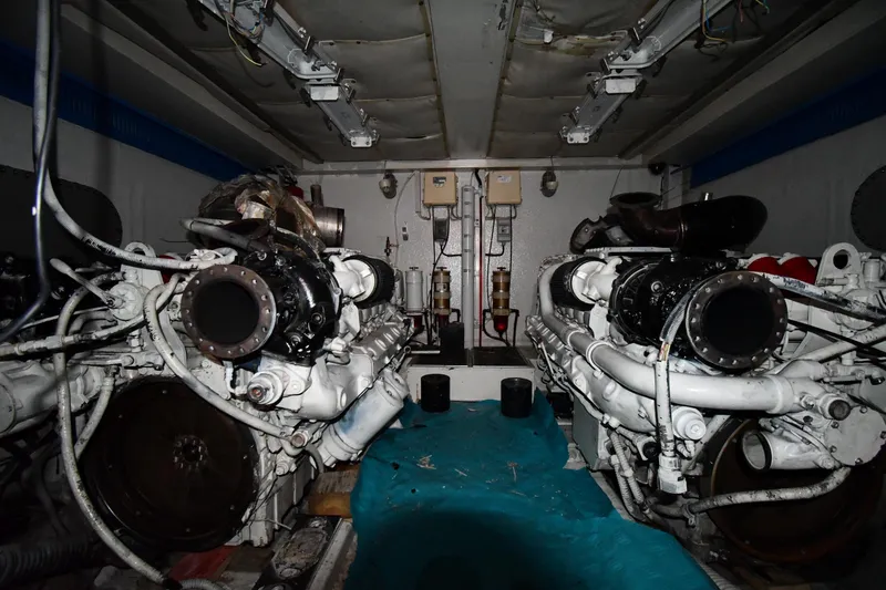 Slide: The Image of Engine room of a 2001 Ferretti Yachts 72, showcasing dual engines and mechanical components. - 122