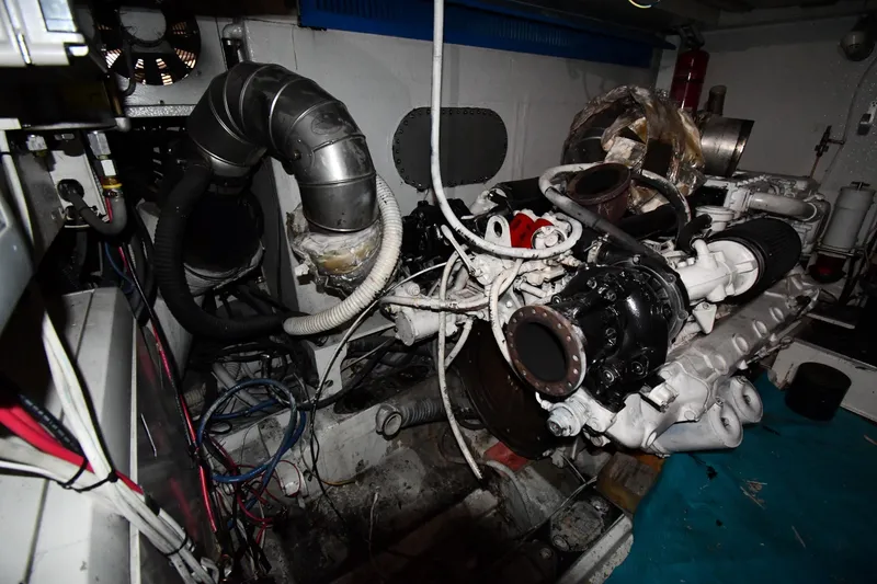 Slide: The Image of Engine room of a 2001 Ferretti Yachts 72, showcasing mechanical components and wiring. - 124