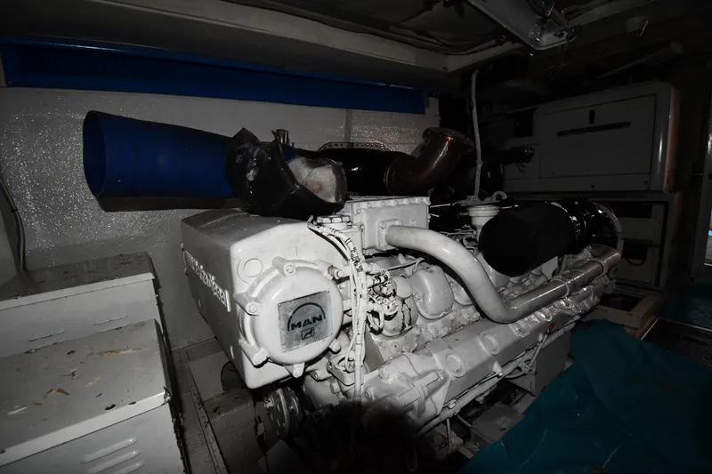 Slide: The Image of Engine room of a 2001 Ferretti Yachts 72, featuring a MAN engine. - 128