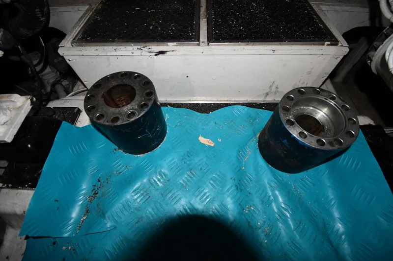 Slide: The Image of Engine room components on a 2001 Ferretti Yachts 72, featuring metal cylinders on a blue mat. - 129