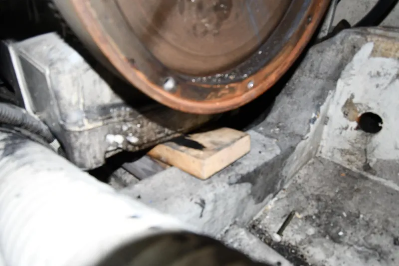 Slide: The Image of Engine compartment of a 2001 Ferretti Yachts 72, showing mechanical components and a wooden block. - 131