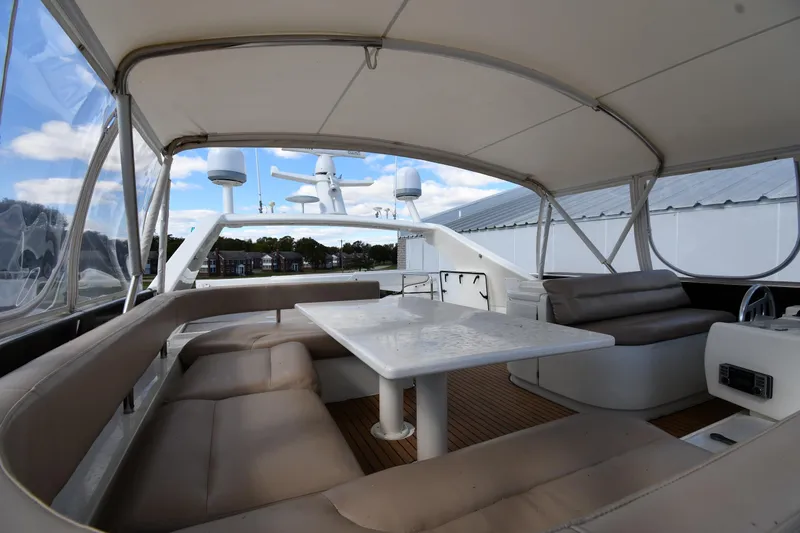 Slide: The Image of Luxurious 2001 Ferretti Yachts 72 flybridge with seating and table under canopy. - 31