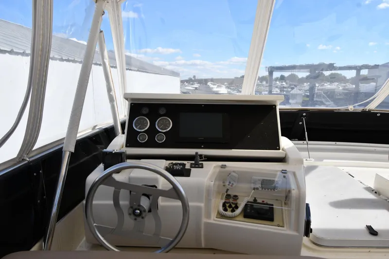 Slide: The Image of Cockpit of 2001 Ferretti Yachts 72 with steering wheel and navigation instruments. - 34