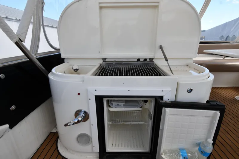 Slide: The Image of Outdoor kitchen on 2001 Ferretti Yachts 72 with grill and mini fridge. - 40