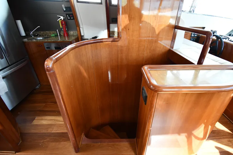 Slide: The Image of Interior of 2001 Ferretti Yachts 72, featuring wooden staircase and modern kitchen area. - 42