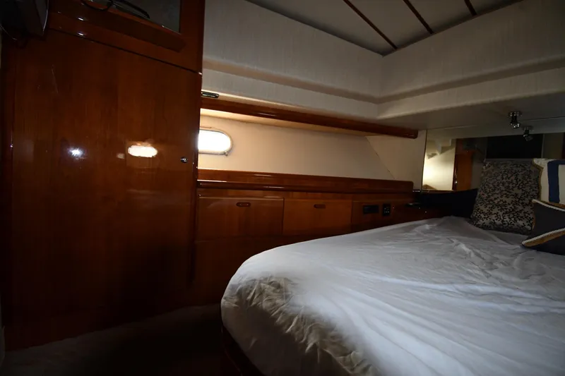 Slide: The Image of Luxurious cabin interior of 2001 Ferretti Yachts 72 with wood finish and cozy bedding. - 47