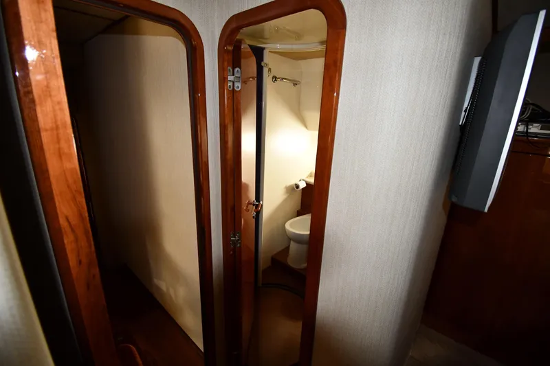 Slide: The Image of Interior of 2001 Ferretti Yachts 72, featuring a compact bathroom with wooden accents. - 51