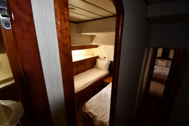 Slide: The Image of Cozy cabin interior of 2001 Ferretti Yachts 72, featuring wooden finishes and comfortable bedding. - 55