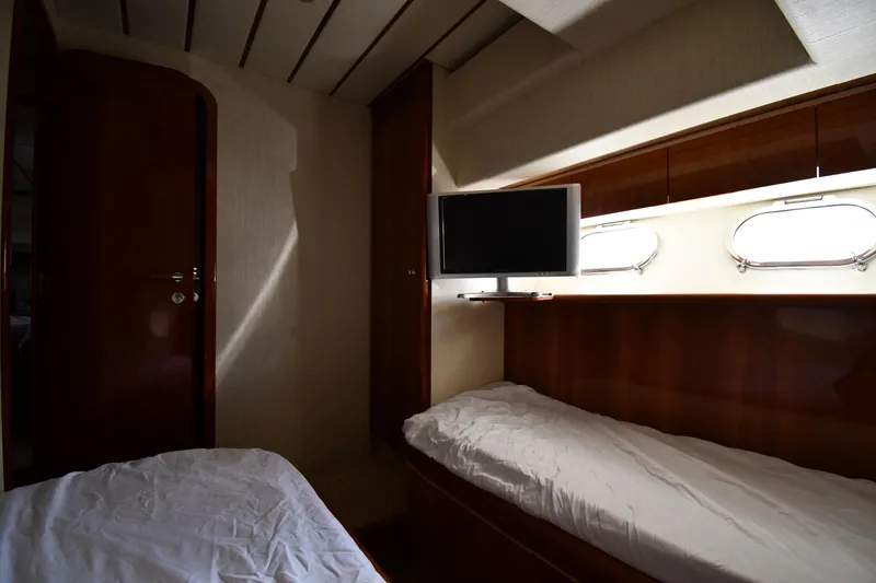Slide: The Image of Interior cabin of 2001 Ferretti Yachts 72 with twin beds and wall-mounted TV. - 57