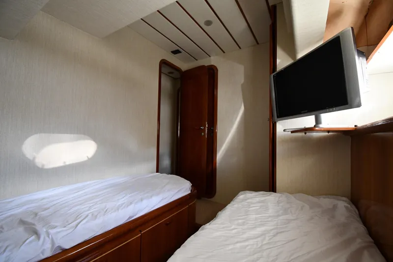 Slide: The Image of Interior cabin of 2001 Ferretti Yachts 72 with twin beds and wall-mounted TV. - 58