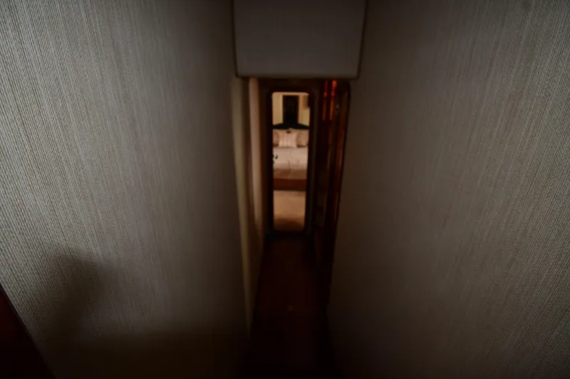 Slide: The Image of Narrow hallway inside 2001 Ferretti Yachts 72, leading to a cozy cabin. - 60
