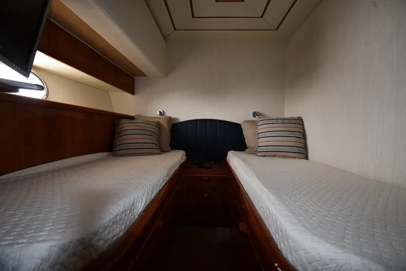 Slide: The Image of Twin cabin interior of 2001 Ferretti Yachts 72, featuring cozy beds and striped pillows. - 63