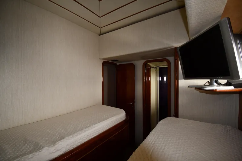 Slide: The Image of Interior cabin of 2001 Ferretti Yachts 72 with twin beds and wall-mounted TV. - 65