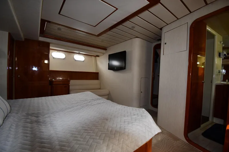 Slide: The Image of Luxurious bedroom interior of 2001 Ferretti Yachts 72 with elegant wood finishes and modern amenities. - 73