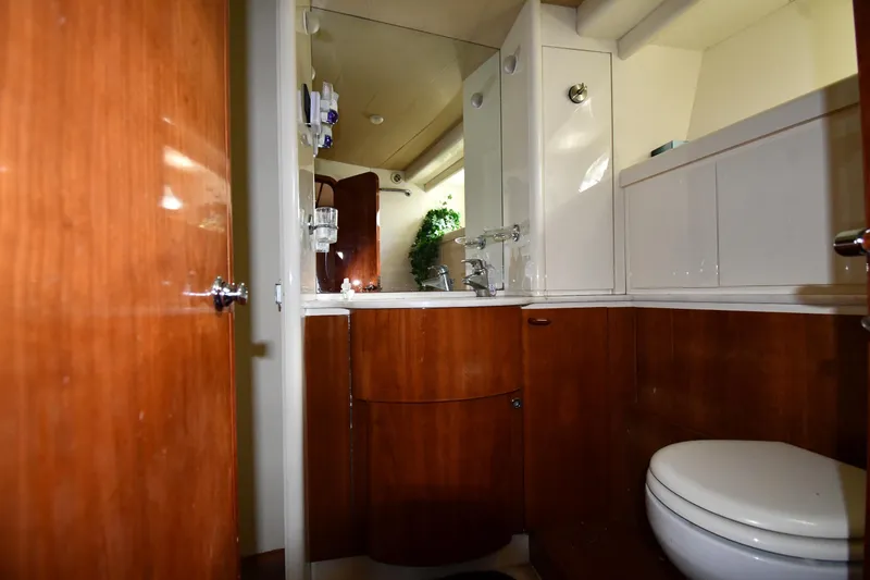 Slide: The Image of Luxurious bathroom in 2001 Ferretti Yachts 72, featuring wood cabinetry and modern fixtures. - 76