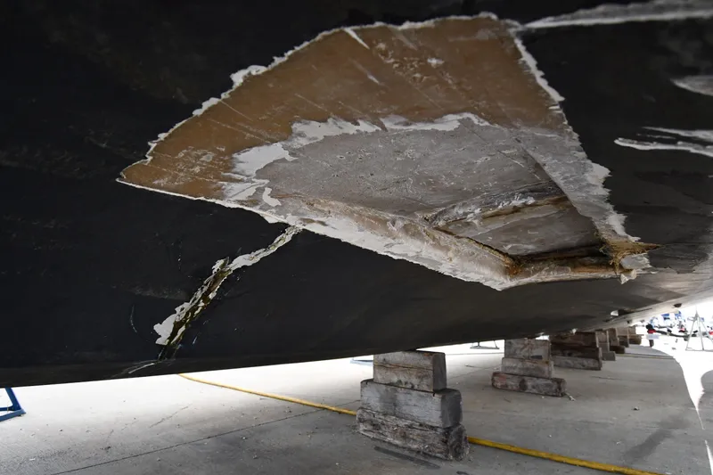 Slide: The Image of Damaged hull of a 2001 Ferretti Yachts 72, supported on blocks for repair. - 8