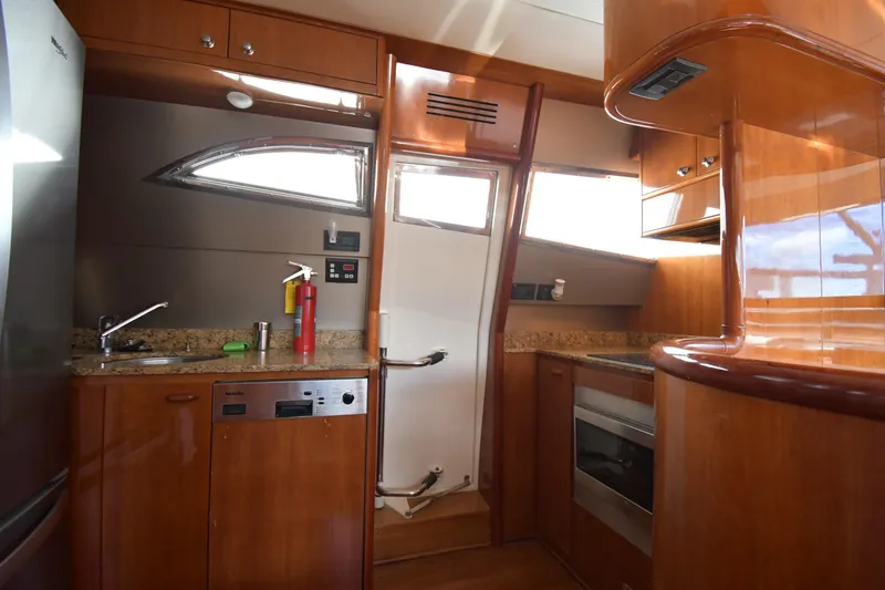 Slide: The Image of Luxurious 2001 Ferretti Yachts 72 kitchen with wood cabinetry and modern appliances. - 89