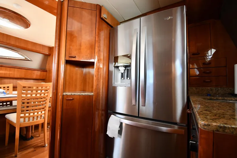 Slide: The Image of Luxurious kitchen interior of 2001 Ferretti Yachts 72 with stainless steel fridge and wooden cabinetry. - 90