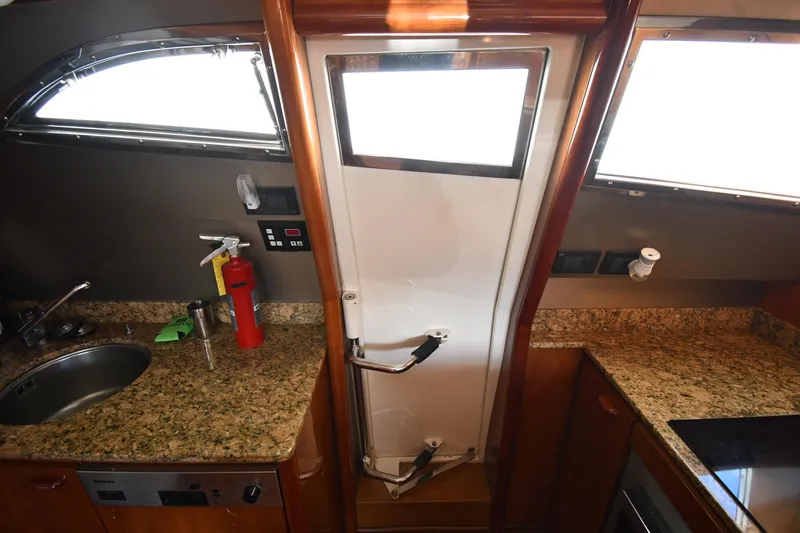 Slide: The Image of Luxurious 2001 Ferretti Yachts 72 kitchen with granite countertops and modern amenities. - 91