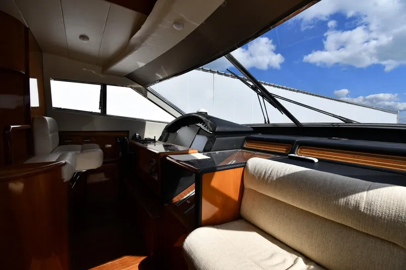 Slide: The Image of Interior of 2001 Ferretti Yachts 72, featuring helm and seating under blue sky. - 97