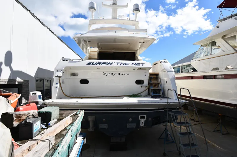 Slide: The Image of 2001 Ferretti Yachts 72 docked, rear view, with "Surfin' the Net" text, sunny day. - 10