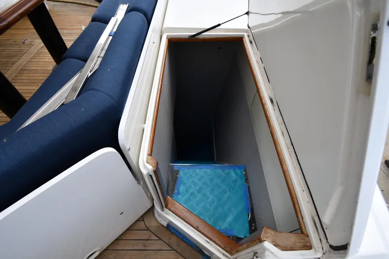 Slide: The Image of Open storage compartment on 2001 Ferretti Yachts 72, featuring blue cushioned seating. - 107